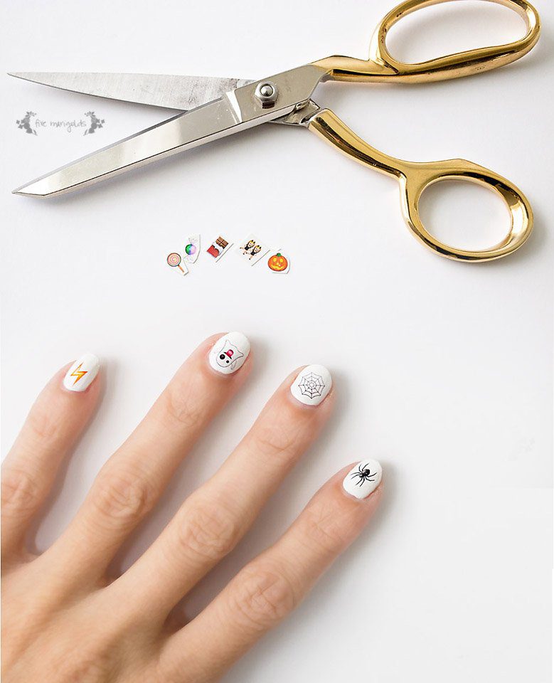 What a neat idea! Use tattoo paper to make nail art. Halloween Emoji nails.