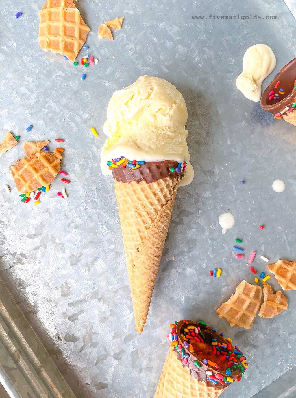 Marshmallow vanilla ice cream cones on steel background with sprinkles