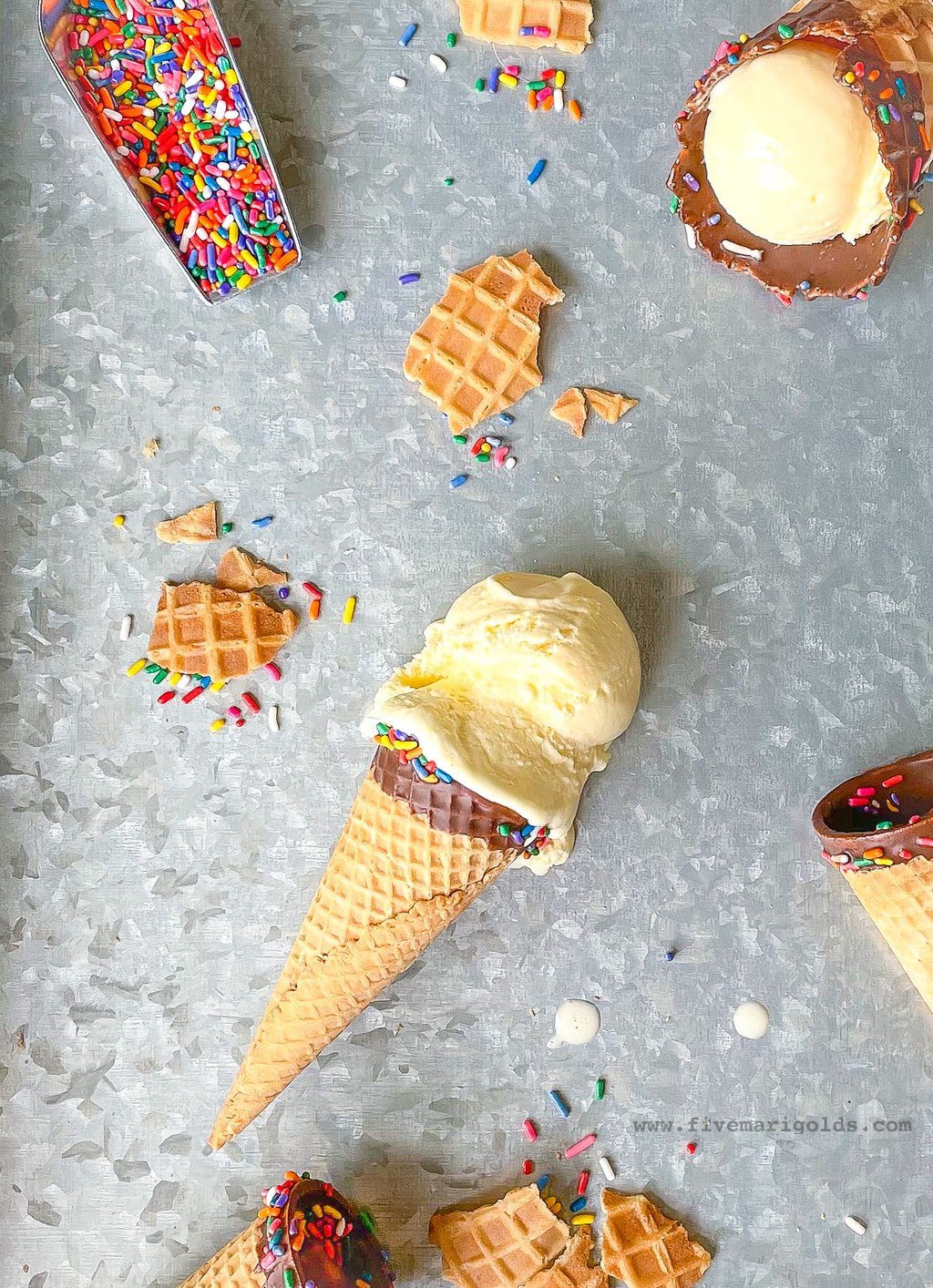 Marshmallow vanilla ice cream cones on metal background with sprinkles