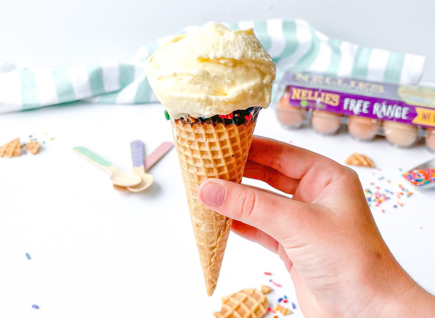 Child's hand holding marshmallow vanilla ice cream cone
