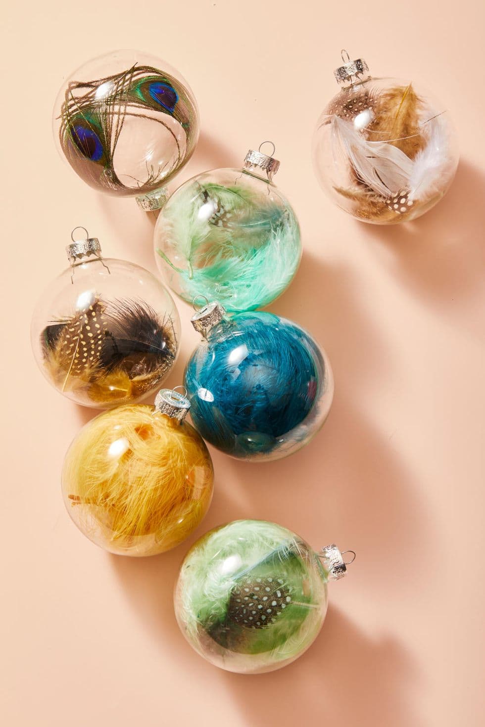 clear treasure ornaments filled with colorful feathers