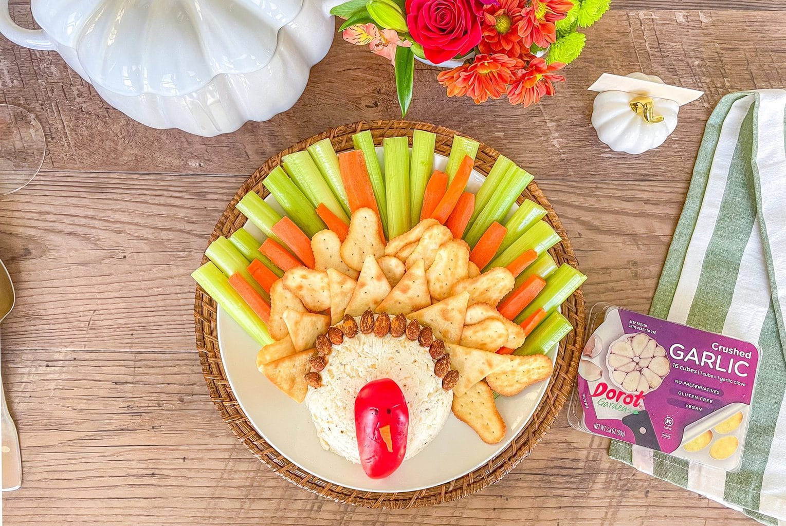 Cheese ball made to resemble a turkey with a red pepper face, and carrots, celery and crackers for the feathers.